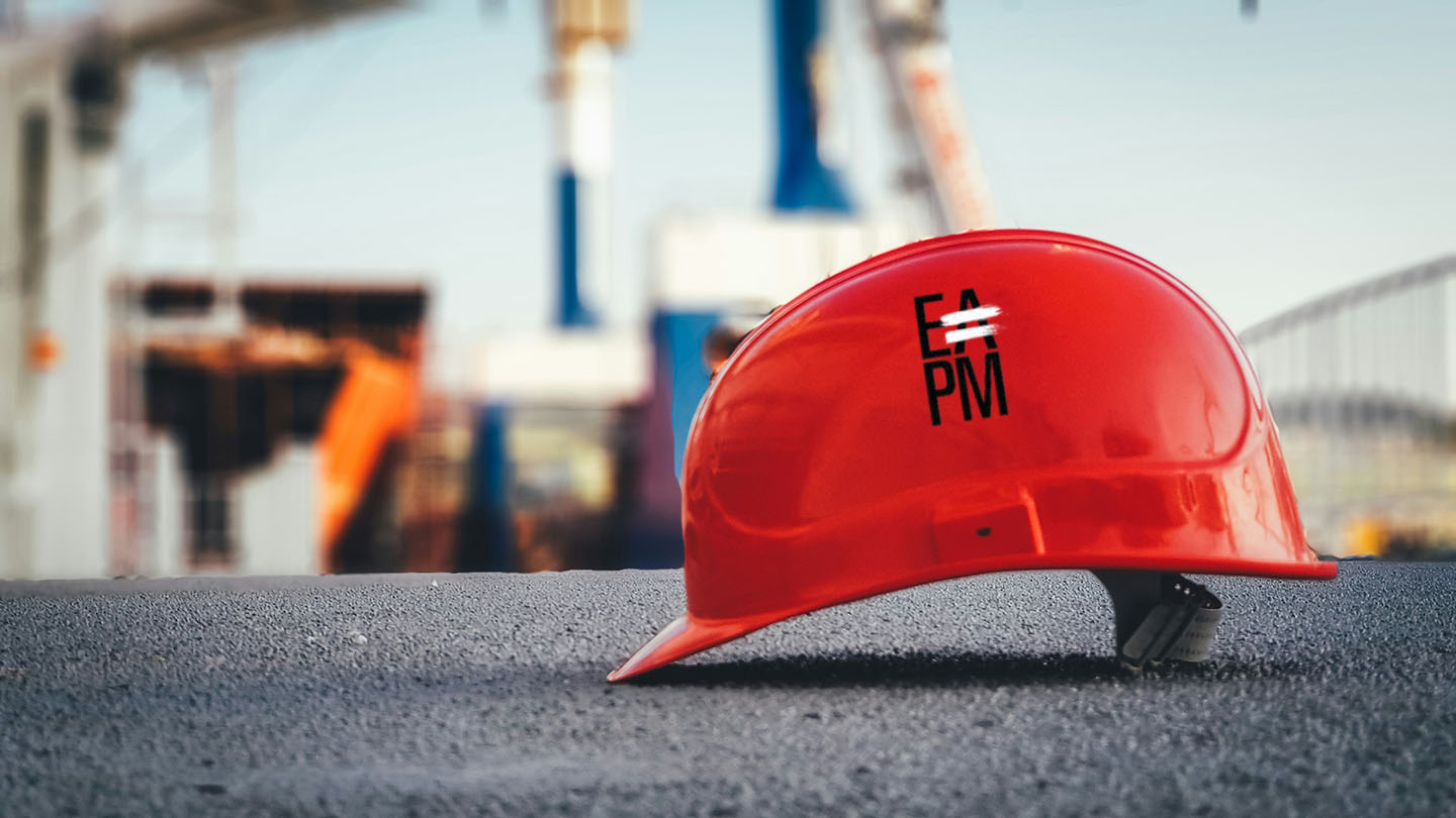 A red hardhat with the EAPM logo